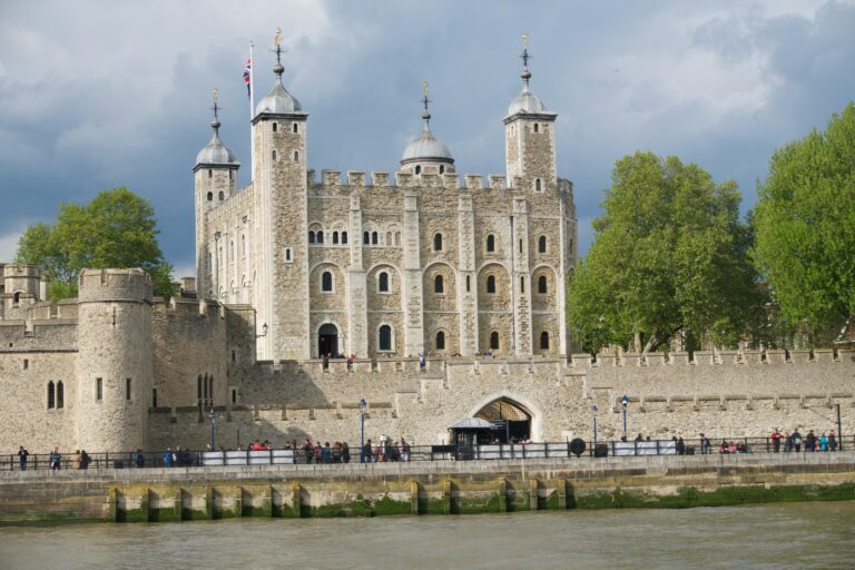 A postcard style photo of the Tower of London, viewed from the River Thames.